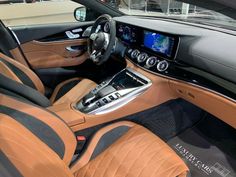 the interior of a car with tan leather and black trim