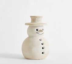 a white ceramic snowman with a hat on