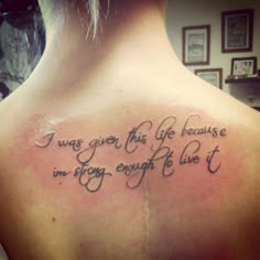 a woman with a tattoo on her back saying i was given this life because i'm strong enough to live it