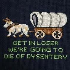 a close up of a cross stitch pattern on a sweater with an image of a horse pulling a wagon