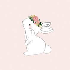 a white rabbit with a flower crown on its head sitting in front of a pink background