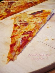 two slices of pizza sitting on top of a cutting board