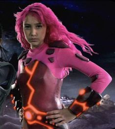 two women in futuristic outfits standing next to each other with neon hair and glowing eyes