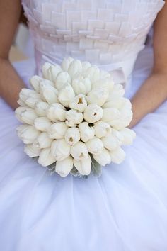 the bride's bouquet is made up of white tulips