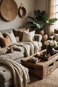 a living room filled with lots of furniture next to a large potted plant on top of a table