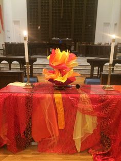 the table is covered with red and yellow cloths