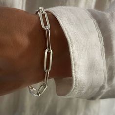 Large heavy link Silver Flat Paperclip Bracelet - worn on its own this chain goes with everything and fantastic layered with your other favourites. Finished with a sterling silver clasp. Adjustable length - clasp can attach anywhere along the chain. Large 17.5mm x 6mm x 1mm  links  all components are Solid 925 Sterling Silver for matching necklace go here https://sarahtaylordesigns.etsy.com/listing/1593927236 Luxury Silver Chain Bracelet With Solid Link Construction, Luxury Polished Silver Link Chain Bracelet, Luxury Adjustable Bracelet With Sterling Silver Clasp, Luxury Modern Bracelets With Silver Chain, Luxury Silver Bracelets With Stainless Steel Clasp, Adjustable Bracelet Clasp, Luxury Silver Bracelet With Clasp, Luxury Gift Chain Bracelet With Sterling Silver Clasp, Luxury Statement Sterling Silver Link Bracelet