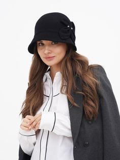 Discover the timeless elegance of our Women's Winter Cloche Hat, a perfect blend of classic style and modern comfort. Inspired by the iconic flapper era, this wool hat is a nod to the glamorous Gatsby days, bringing a touch of vintage charm to your wardrobe. Available in two sophisticated colors - classic black and a deep, dark blue - this hat is designed to complement any outfit, whether you're dressing up for a special occasion or adding a stylish accent to your everyday wear. Crafted with the highest quality wool, our cloche hat promises not only style but also warmth and comfort during the colder months. The wool fabric is carefully selected for its softness and durability, ensuring that the hat maintains its shape and elegance over time. The snug fit of the cloche design is both pract Luxury Wool Brimmed Cloche Hat, Luxury Brimmed Wool Cloche Hat, Luxury Classic Cloche Hat For Fall, Luxury Casual Brimmed Cloche Hat, Luxury Women's Cloche Felt Hat, Luxury Flat Brim Cloche Hat For Winter, Luxury Wool Classic Cloche Hat, Chic Luxury Cloche Hat For Women, Luxury Classic Cloche Hat With Curved Brim