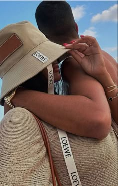 a man and woman embracing each other with the words love on their ribbons around their necks