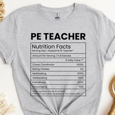 a t - shirt that says pe teacher nutrition fact on it, sitting next to some other items