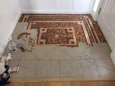 the floor is made out of small tiles and has been laid on top of it