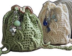 three crocheted bags are sitting next to each other