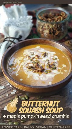 butternut squash soup with maple pumpkin seed crumbles in a bowl on a wooden table