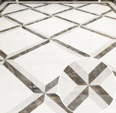 a white and black tiled floor with a circular design