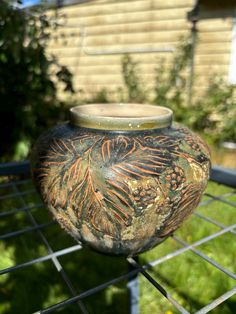 a vase sitting on top of a metal rack