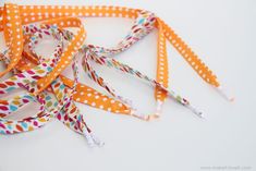 there are many different colored polka dots on this lanyards ribbon, and one is multicolored