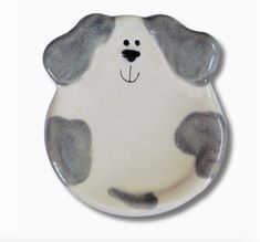 a ceramic plate with a dog's face painted on it