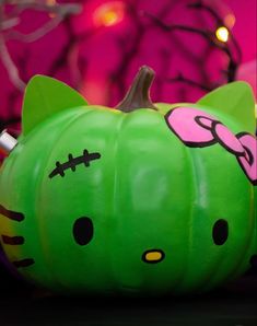 a green hello kitty pumpkin sitting on top of a table