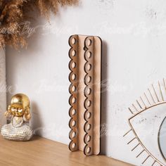 a wooden shelf with a decorative object on it and a mirror in the corner next to it