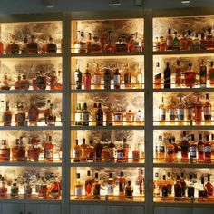 shelves filled with different types of liquor bottles