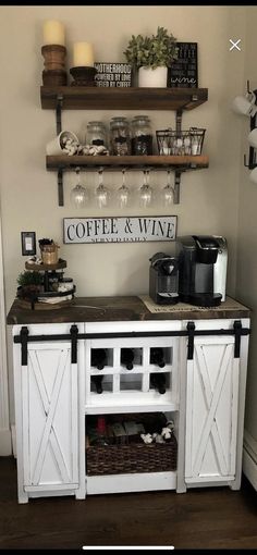 a coffee bar with wine glasses on the top and two shelves above it that hold drinks