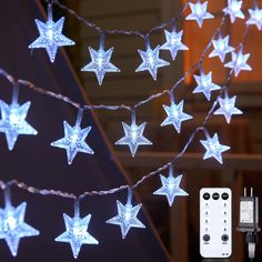 a string of white star lights with remote controls