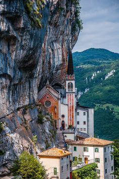 an old church perched on the side of a cliff