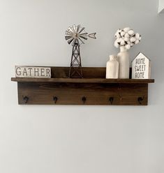 a wooden shelf with some items on it and a windmill in the corner next to it