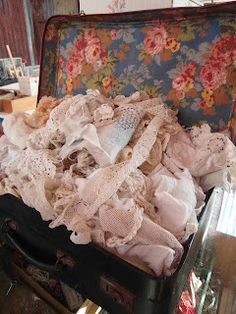 an old suitcase filled with clothes and other items