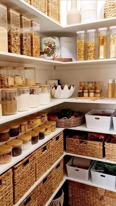 an organized pantry with wicker baskets and food in the bins on the shelves