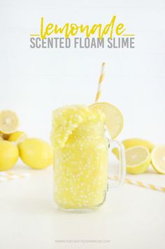 a mason jar filled with lemonade next to sliced lemons