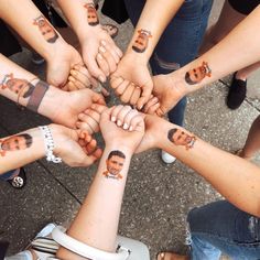 a group of people holding their hands together