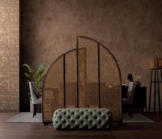 a living room with a couch, table and chair next to a brick wall in the background