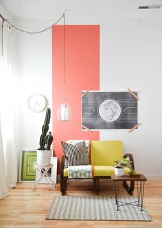 a living room with a couch, table and two clocks on the wall behind it