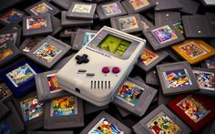 an old nintendo gameboy surrounded by video games