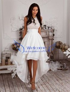 a woman in a white dress standing on a wooden floor