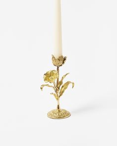 a candle that has some flowers on it