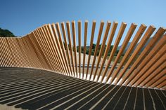 a wooden fence is shown with shadows on the ground