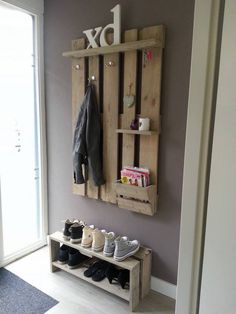 a wall mounted shelf filled with shoes next to a window