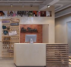 the inside of a store with many signs on the wall and wood slats in front of it