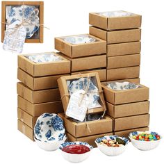 several boxes are stacked on top of each other with blue and white dishes in them