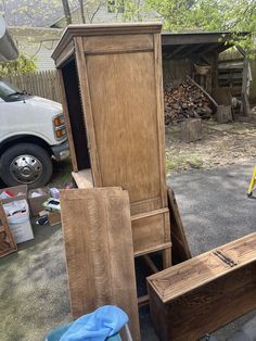 several pieces of wood are stacked on top of each other in front of a truck