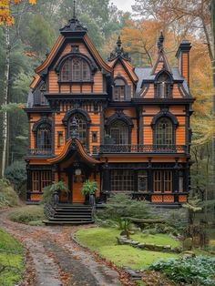 an orange and black house in the woods