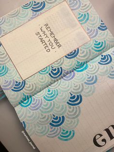 an open notebook with blue and white designs on it