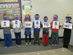 five children holding up signs with the words i love to read in front of them