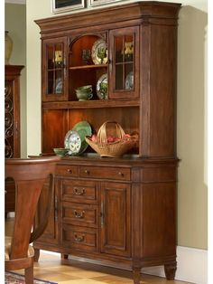 a dining room table and hutch with china cabinet