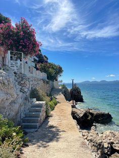 the path to the beach is lined with steps leading up to the water's edge