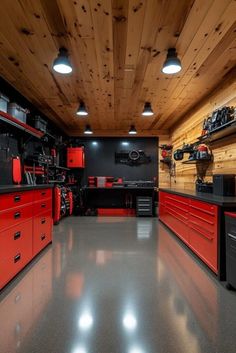 a garage filled with lots of red and black cabinets