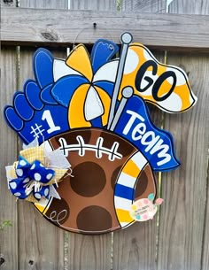 a football themed door hanger on a fence