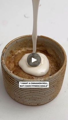 a spoon is pouring cream into a bowl with cookies in it and the caption says, i want a cinnamon roll but i have fitness goals